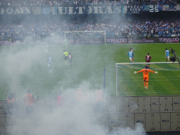 Players on the pitch and smoke at the Stadio Diego Armando Maradona stadium, viewed from the Curva A Inferiore grandstand, during the football match SSC Napoli - Salernitana