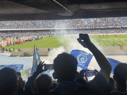 Players on the pitch and football fans at the Curva B grandstand celebrating a SSC Napoli goal at the Stadio Diego Armando Maradona stadium, during the football match SSC Napoli - Salernitana