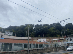 Airplane flying over the Capodimonte hill, viewed from the Via Capodimonte street