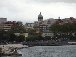 The southwest side of the Acquario di Napoli aquarium at the Villa Comunale park and the dome of the Santa Maria degli Angeli a Pizzofalcone church, viewed from the Via Caracciolo Francesco street