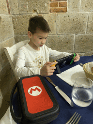 Max playing on the Nintendo Switch at the Ristorante Osteria Sannazaro restaurant