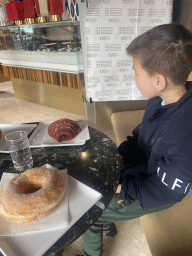 Max with donut and bread at the Zenit Café