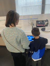 Miaomiao and Max with a robot hand at the Corporea building at the east side of the Città della Scienza museum