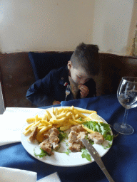 Max eating schnitzel and fries at the La Cantina di Coroglio restaurant