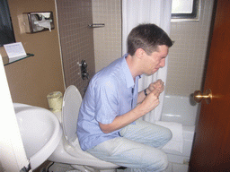 Tim on the toilet of our hotel room of the Clarion Hotel Park Avenue