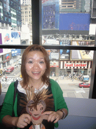 Miaomiao with a plush Lion King, and Times Square