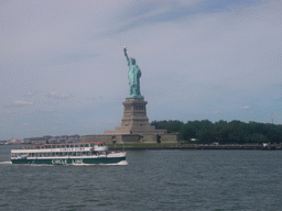 The Statue of Liberty and a boat from the Liberty Island ferry