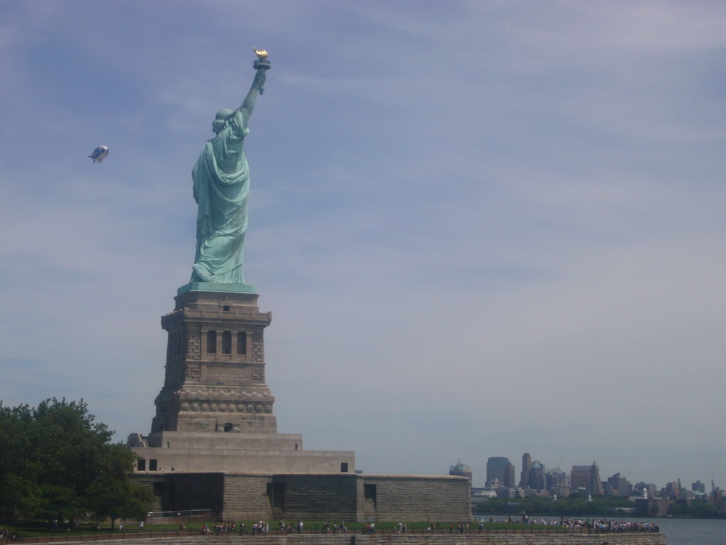 The Statue of Liberty, a zeppelin and the skyline of Manhattan, from the Liberty Island - Ellis Island ferry