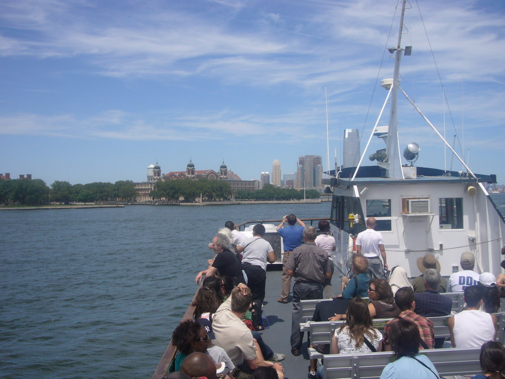 Ellis Island, the skyline of Jersey City and people on the ferry, from the Liberty Island - Ellis Island ferry