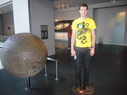 Tim on a moon weight balance in the Hayden Planetarium