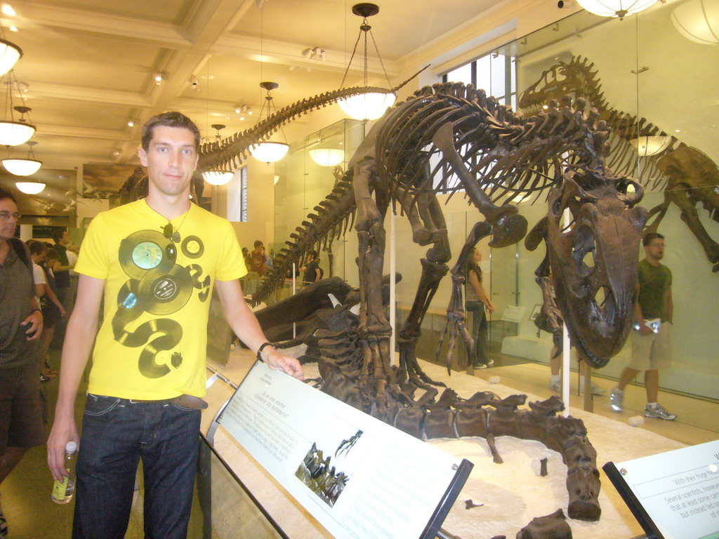 Tim with a skeleton of an Allosaurus, in the Hall of Saurischian Dinosaurs, in the American Museum of Natural History
