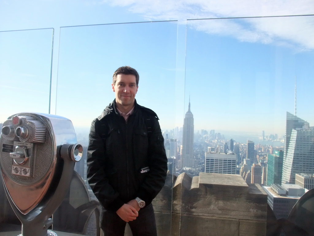 Tim at the `Top of the Rock` Observation Deck at the GE Building of Rockefeller Center, with a view on the skyline of Manhattan with the Empire State Building