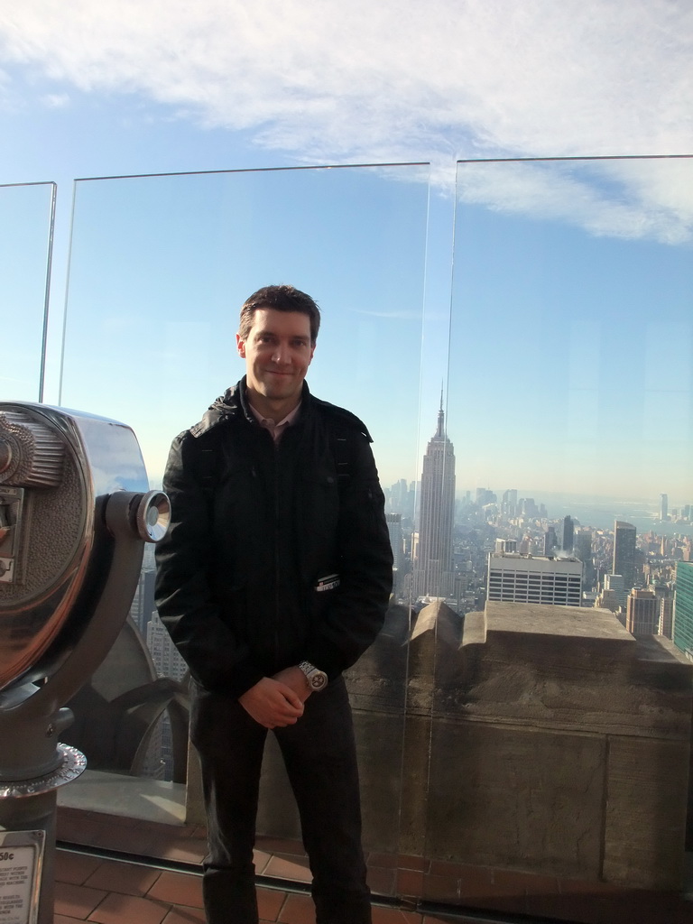 Tim at the `Top of the Rock` Observation Deck at the GE Building of Rockefeller Center, with a view on the skyline of Manhattan with the Empire State Building