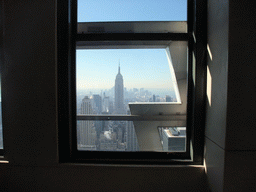 Skyline of Manhattan with the Empire State Building, viewed through a window at the `Top of the Rock` Observation Deck at the GE Building of Rockefeller Center