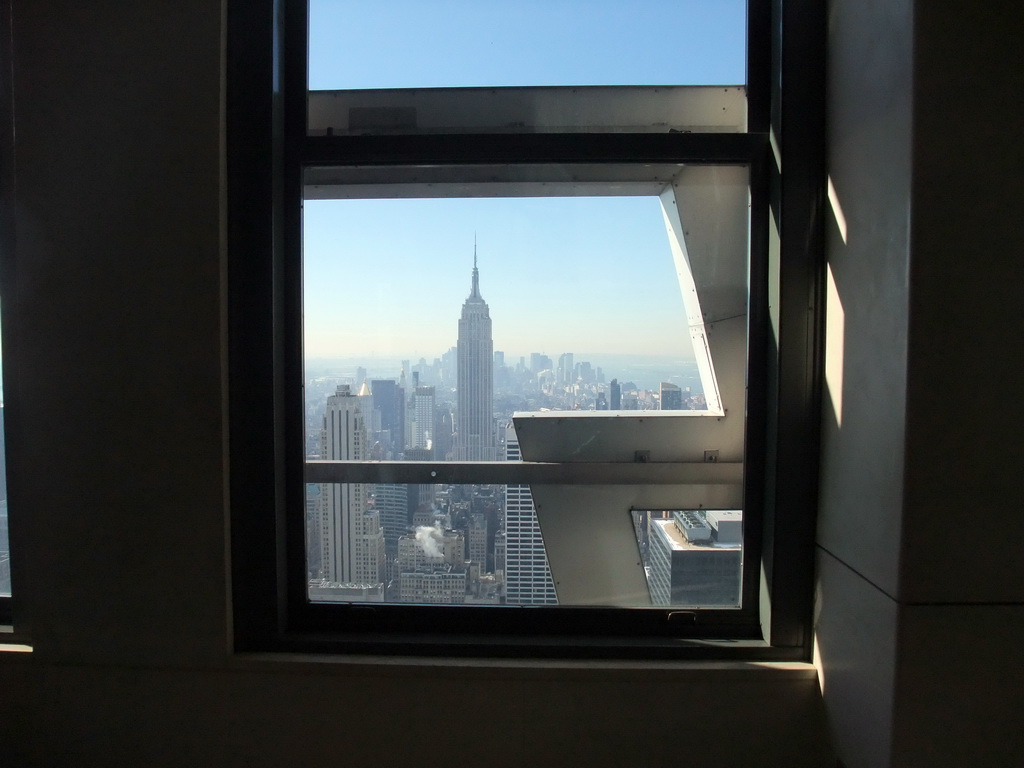 Skyline of Manhattan with the Empire State Building, viewed through a window at the `Top of the Rock` Observation Deck at the GE Building of Rockefeller Center
