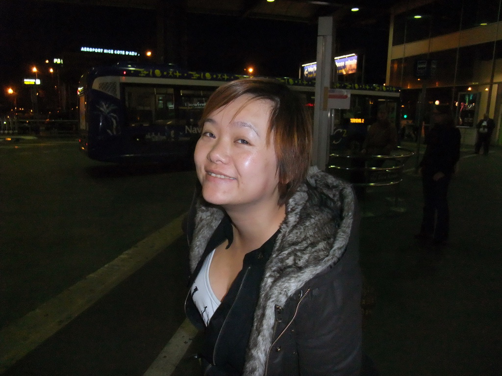 Miaomiao at the bus station of Nice Côte d`Azur Airport, by night