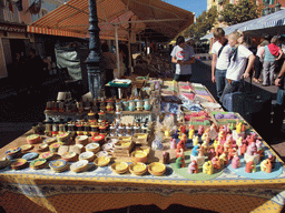 Market stall with soaps and dinnerware at the Marché aux Fleurs market at the Cours Saleya street, at Vieux-Nice