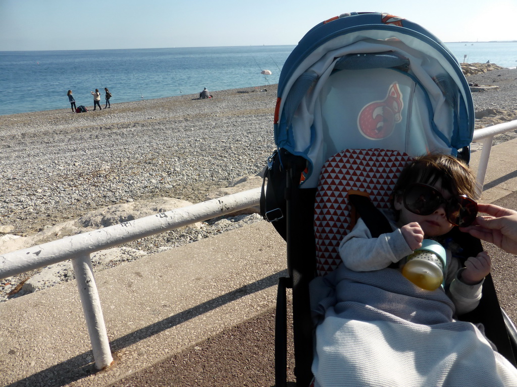 Max with sunglasses having a drink and the beach at the Promenade des Anglais