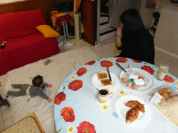 Miaomiao having breakfast and Max on the floor of the living room of our holiday home `Maisonnette`