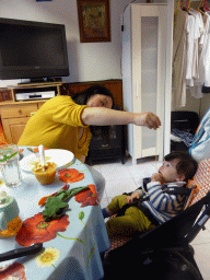 Miaomiao feeding Max spaghetti in the living room of our holiday home `Maisonnette`
