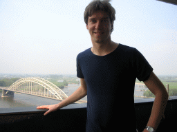 Tim at the replica of the Donjon tower at the Valkhof park, with a view on the Waalbrug bridge over the Waal river