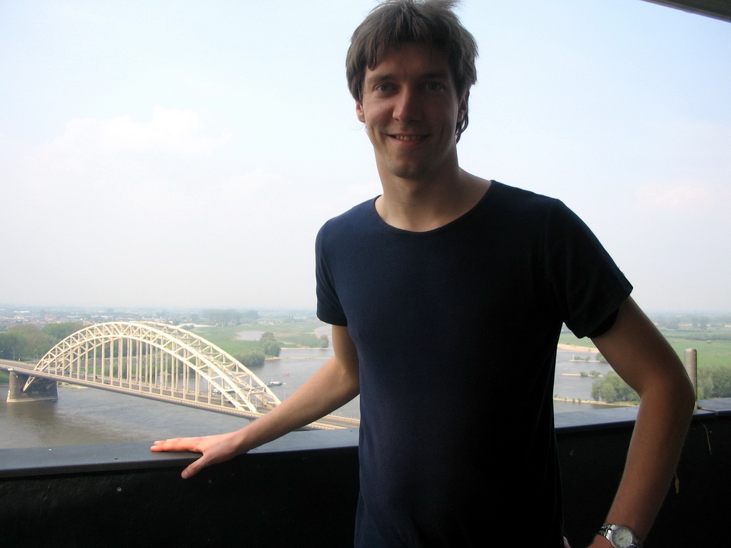 Tim at the replica of the Donjon tower at the Valkhof park, with a view on the Waalbrug bridge over the Waal river