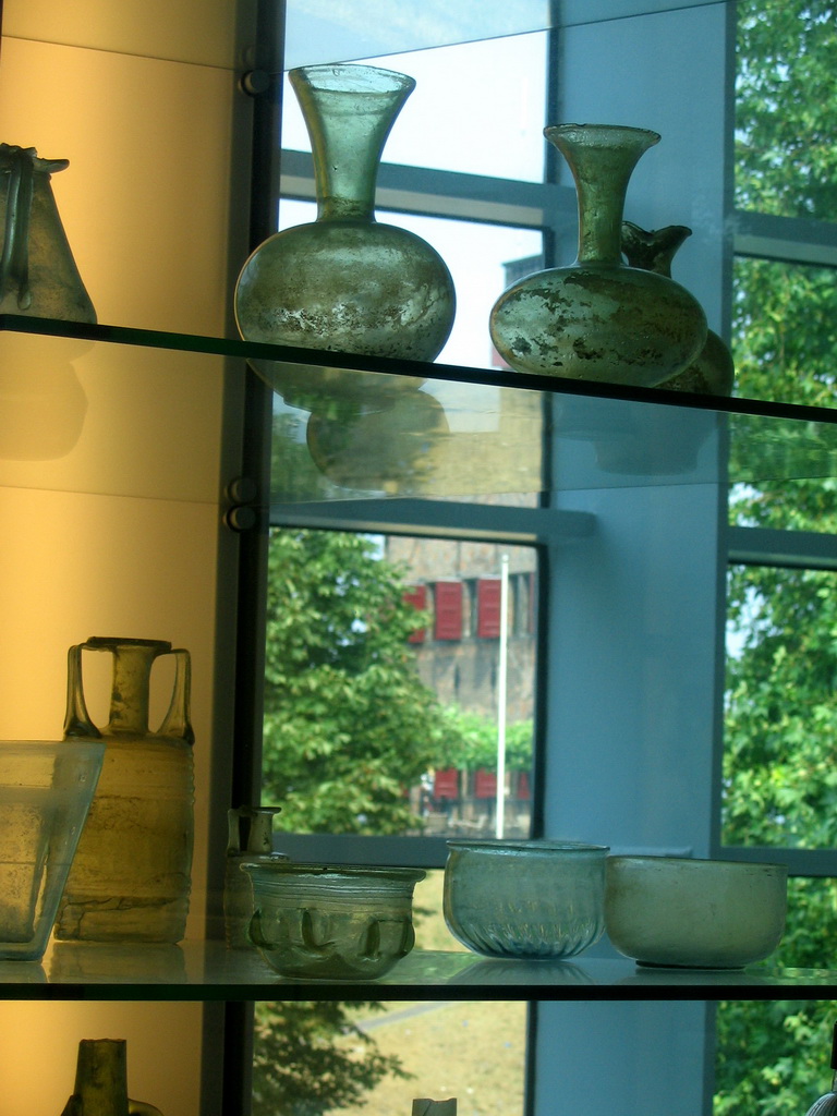 Roman vases at the Valkhof museum, with a view on the Belvédère tower
