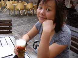 Miaomiao drinking a beer on the terrace of the Stadsbrouwerij De Hemel brewery