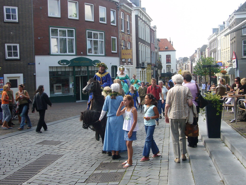 People in medieval clothes and horses at the Ganzenheuvel square, during the Gebroeders van Limburg Festival