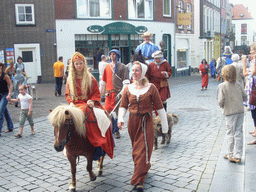 People in medieval clothes, horses and a falcon at the Ganzenheuvel square, during the Gebroeders van Limburg Festival