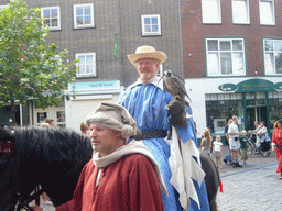 People in medieval clothes, a horse and a falcon at the Ganzenheuvel square, during the Gebroeders van Limburg Festival