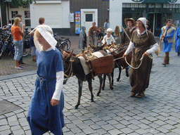 People in medieval clothes and donkeys at the Ganzenheuvel square, during the Gebroeders van Limburg Festival