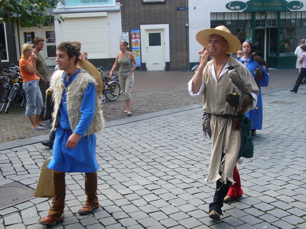 People in medieval clothes and falcons at the Ganzenheuvel square, during the Gebroeders van Limburg Festival