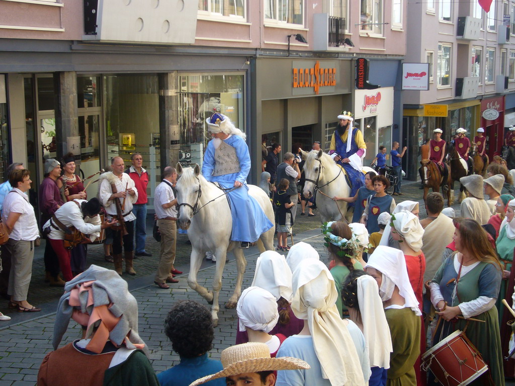 People in medieval clothes and horses at the Houtstraat street, during the Gebroeders van Limburg Festival