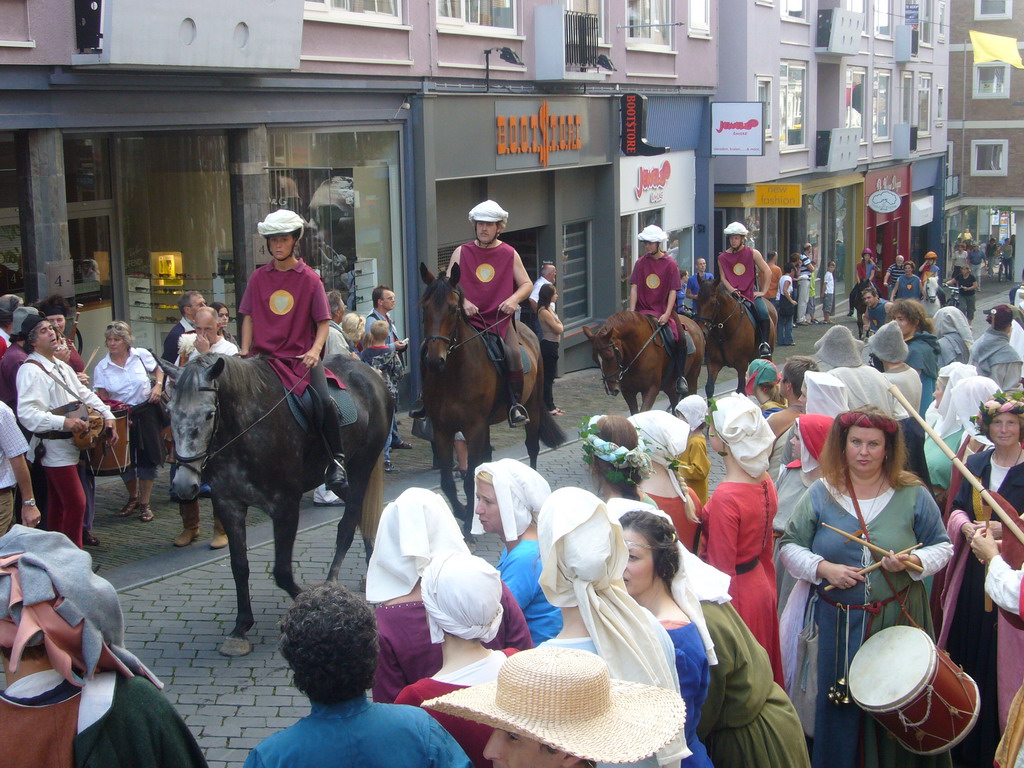 People in medieval clothes and horses at the Houtstraat street, during the Gebroeders van Limburg Festival