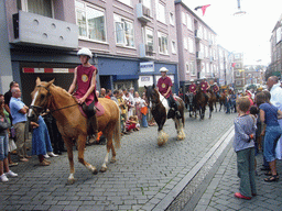 People in medieval clothes and horses at the Houtstraat street, during the Gebroeders van Limburg Festival