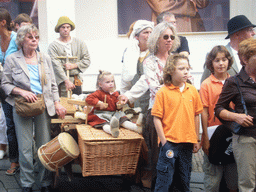 People in medieval clothes and a cart at the Houtstraat street, during the Gebroeders van Limburg Festival