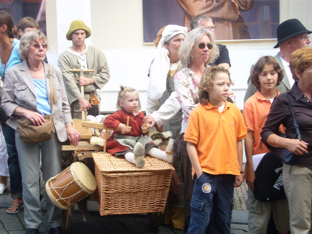People in medieval clothes and a cart at the Houtstraat street, during the Gebroeders van Limburg Festival