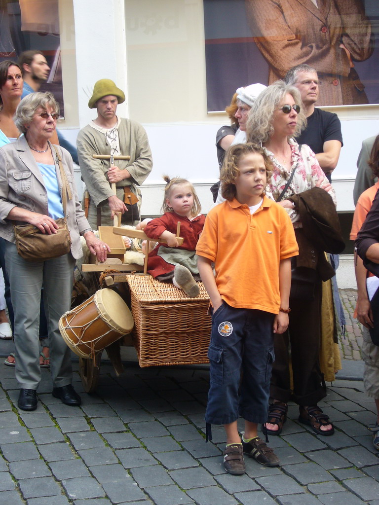 People in medieval clothes and a cart at the Houtstraat street, during the Gebroeders van Limburg Festival