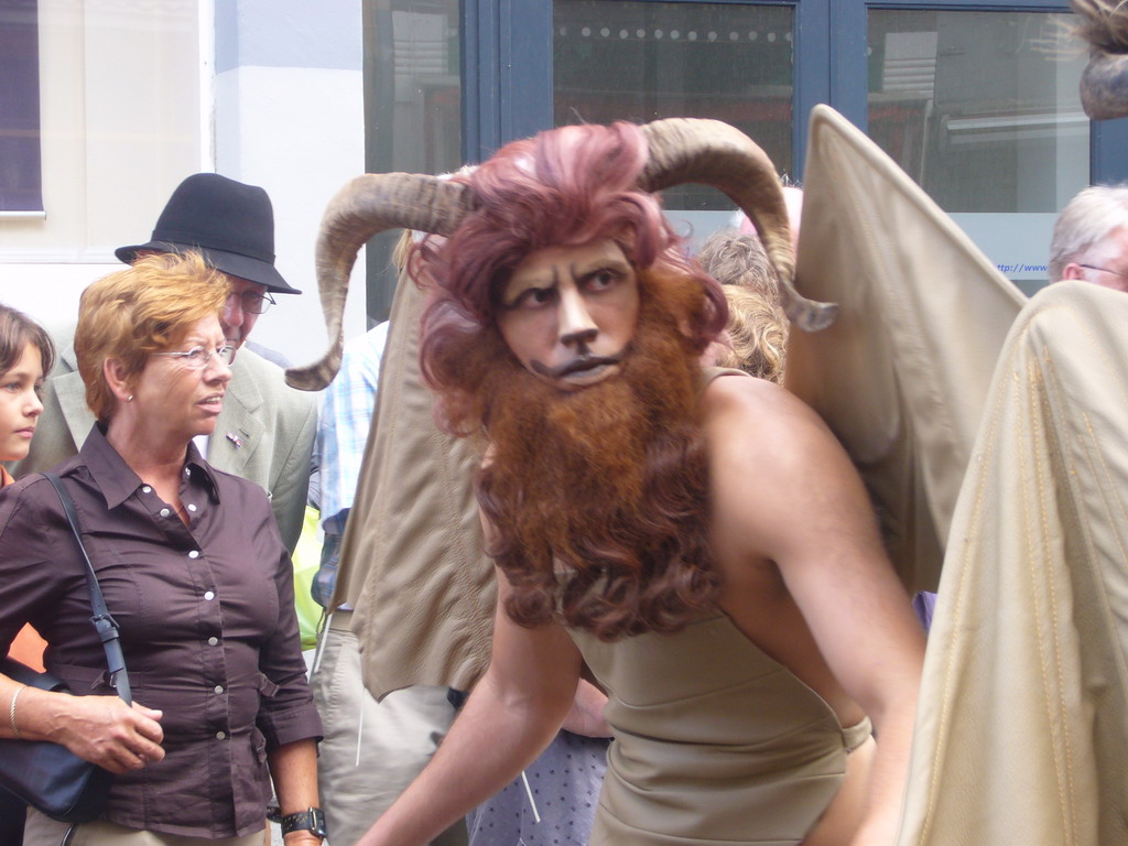 Person dressed as a mythological creature at the Houtstraat street, during the Gebroeders van Limburg Festival