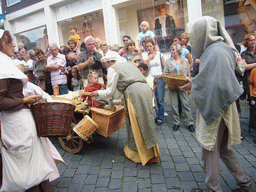 People in medieval clothes and a cart at the Houtstraat street, during the Gebroeders van Limburg Festival