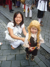Miaomiao with a child in medieval clothes at the Houtstraat street, during the Gebroeders van Limburg Festival