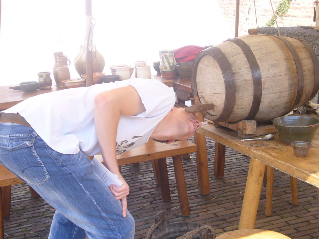 Tim drinking from a tap at the Sint Stevenskerkhof square, during the Gebroeders van Limburg Festival