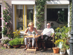 People sitting in front of their house at the Sint Stevenskerkhof square