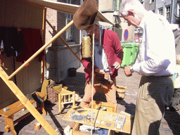 Person in medieval clothes making jewellery at the Sint Stevenskerkhof square, during the Gebroeders van Limburg Festival