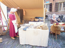 People in medieval clothes selling clothes at the Sint Stevenskerkhof square, during the Gebroeders van Limburg Festival