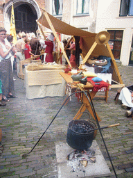 Person in medieval clothes selling food at the Sint Stevenskerkhof square, during the Gebroeders van Limburg Festival