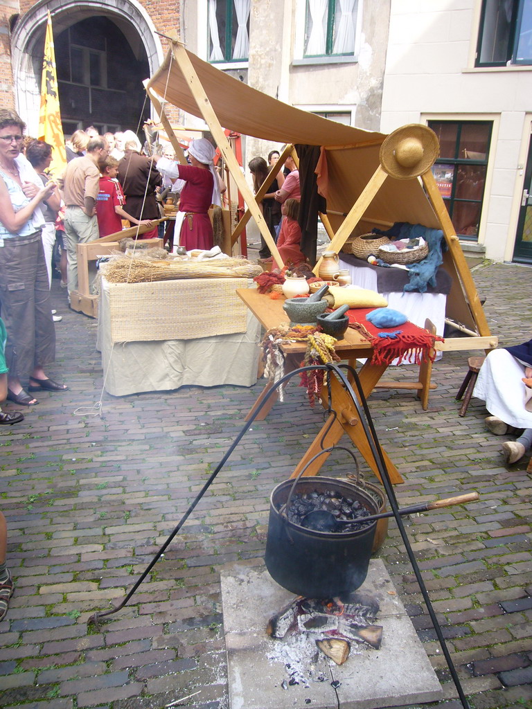 Person in medieval clothes selling food at the Sint Stevenskerkhof square, during the Gebroeders van Limburg Festival
