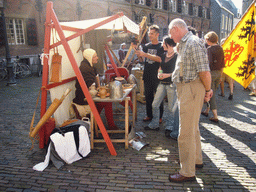 Person in medieval clothes making pottery at the Sint Stevenskerkhof square, during the Gebroeders van Limburg Festival