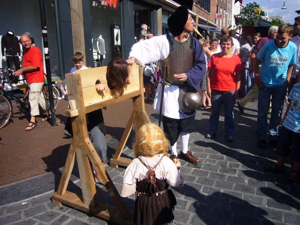 People in medieval clothes with a pillory at the Broerstraat street, during the Gebroeders van Limburg Festival